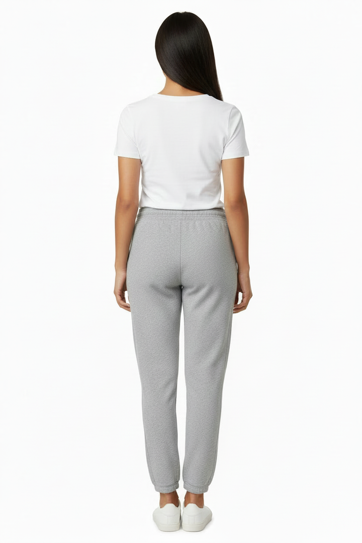 Back view of woman wearing very light heather gray pocket-free jogger sweatpants