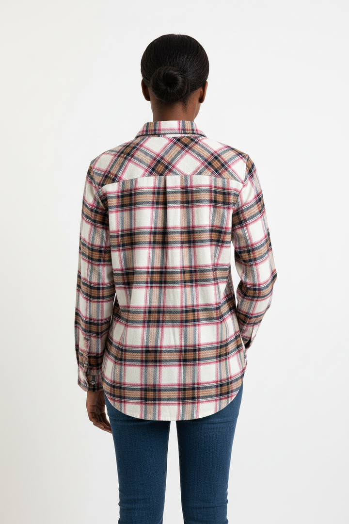 Black woman showing back of flannel shirt on white background