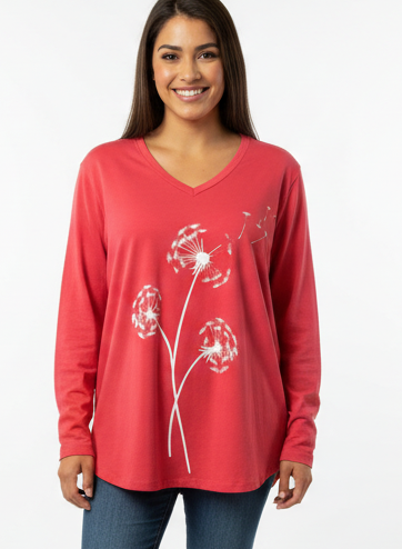 Smiling woman wearing the V-neck dandelion tee with a smaller source-matched print